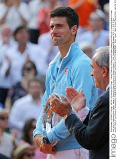 Novak Djokovic of Serbia holds the runners-up trophy after losing his French Open men s final match against Rafael Nadal of Spain at Roland Garros in Paris on June 8, 2014. Nadal defeated Djokovic 3-6, 7-5, 6-2, 6-4 to win his ninth French Open championship.  PAR20140608712