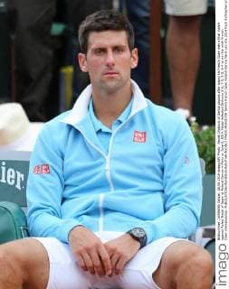 Novak Djokovic of Serbia pauses after losing his French Open men s final match against Rafael Nadal of Spain at Roland Garros in Paris on June 8, 2014. Nadal defeated Djokovic 3-6, 7-5, 6-2, 6-4 to win his ninth French Open championship.  PAR20140608709