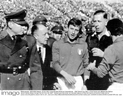 1962 World Cup Italy v Chile Police and referee Ken Ashton escort Italian player Giorgio Ferrini from the field . Heated quarrels broke out between players of the two teams and police finally had to come onto the pitch to escort Ferrini off . 2nd June 1962  kbdig quer UnitedArchives01033780