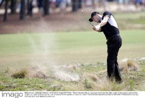 Martin Kaymer hits an approach shot from the 18th rough in the second round of the 114th U.S. Open at Pinehurst No. 2 in Pinehurst North Carolina on June 13, 2014.  PIN20140613103