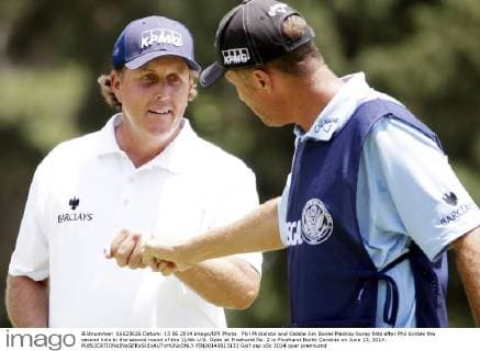 Phil Mickelson and Caddie Jim Bones MacKay bump fists after Phil birdies the second hole in the second round of the 114th U.S. Open at Pinehurst No. 2 in Pinehurst North Carolina on June 13, 2014.  PIN20140613133