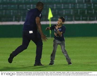 ITAR-TASS: CAMPINAS, BRAZIL. JUNE 13, 2014. A security guard chases a fan at a training session of the Nigerian national football team at Guarani Stadium during the 2014 FIFA World Cup.  Aufmacher kurios RE147296