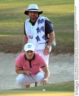 Martin Kaymer celebrates with his caddie Craig Connolly line up a putt on the 16th green during round 3 of the 114th U.S. Open at Pinehurst No. 2 in Pinehurst, North Carolina on June 14, 2014.  PIN20140614333
