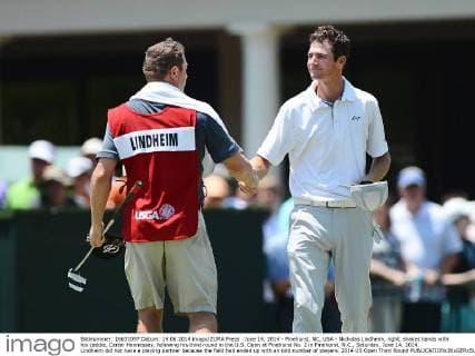June 14, 2014 - Pinehurst, NC, USA - Nicholas Lindheim, right, shakes hands with his caddie, Carter Hennessey, following his third round in the U.S. Open at Pinehurst No. 2 in Pinehurst, N.C., Saturday, June 14, 2014. Lindheim did not have a playing partner because the field had ended up with an odd number of players. 2014 US Open Third Round - ZUMAm67