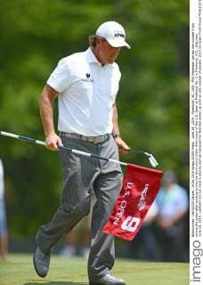 June 14, 2014 - Pinehurst, NC, USA - Phil Mickelson carries the number 9 pin across the green after putting during the third round of the third round of the U.S. Open at Pinehurst No. 2 in Pinehurst, N.C., Saturday, June 14, 2014. Lindheim did not have a playing partner because the field had ended up with an odd number of players. 2014 US Open Third Round - ZUMAm67