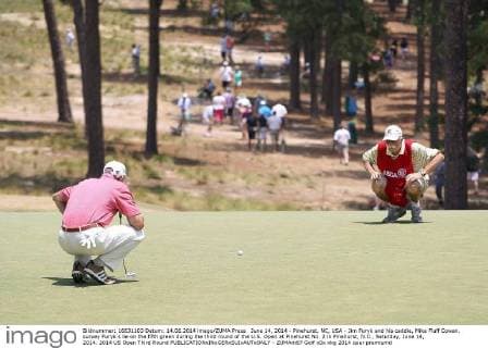 June 14, 2014 - Pinehurst, NC, USA - Jim Furyk and his caddie, Mike Fluff Cowan, survey Furyk s lie on the fifth green during the third round of the U.S. Open at Pinehurst No. 2 in Pinehurst, N.C., Saturday, June 14, 2014. 2014 US Open Third Round - ZUMAm67