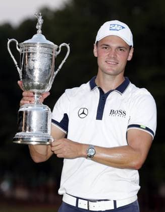 Martin Kaymer holds the championship trophy after the final round of the 114th U.S. Open at Pinehurst No. 2 in Pinehurst North Carolina on June 15, 2014. Kaymer wins the 2014 U.S. Open with a score of 9 under par and a 4 day total of 271.  PIN20140615114