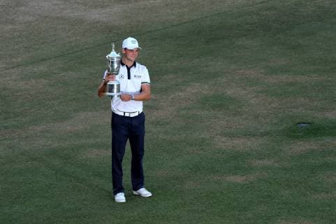 Martin Kaymer poses with the trophy after winning the 114th U.S. Open at Pinehurst No. 2 in Pinehurst, North Carolina on June 15, 2014. Kaymer finished nine under par with a four day score of 271.  PIN20140615338