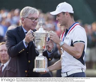Martin Kaymer receives the trophy after winning the 114th U.S. Open at Pinehurst No. 2 in Pinehurst, North Carolina on June 15, 2014. Kaymer finished nine under par with a four day score of 271.  PIN20140615331
