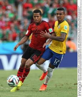 Football - 2014 FIFA World Cup - Group A: Brazil vs. Mexico Giovani dos Santos of Mexico vies with Luis Gustavo of Brazil at the Estadio Castelao, Fortaleza COLORSPORT IAN MACNICOL  5213-1