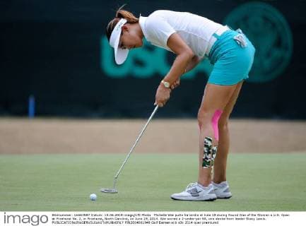 Michelle Wie putts for birdie at hole 18 during Round One of the Women s U.S. Open at Pinehurst No. 2, in Pinehurst, North Carolina, on June 19, 2014. Wie scored a 2-under-par 68, one stroke from leader Stacy Lewis.  PIN2014061949