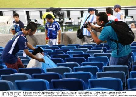 Japan fans (JPN), JUNE 19, 2014 - Football Soccer : Japanese fans have their picture taken by foreign media as they pick up trash off the stands after the FIFA World Cup 2014 Group C match at Estadio das Dunas in Natal . Noxthirdxpartyxsales  (pfta006164)