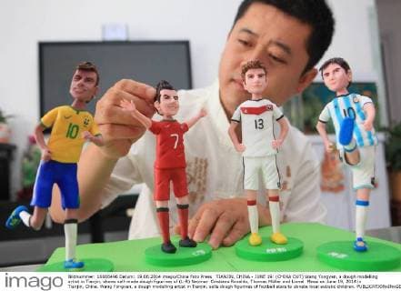 TIANJIN, CHINA - JUNE 19: (CHINA OUT) Wang Yongyan, a dough modelling artist in Tianjin, shows self-made dough figurines of (L-R) Neymar Cristiano Ronaldo, Thomas Müller and Lionel Messi on June 19, 2014 in Tianjin, China. Wang Yongyan, a dough modelling artist in Tianjin, sells dough figurines of football stars to donate local autistic children.  CFP0910 