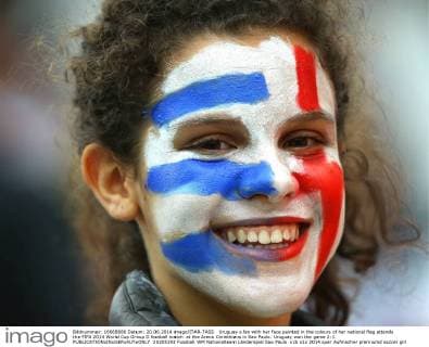 Uruguay s fan with her face painted in the colours of her national flag attends the FIFA 2014 World Cup Group D football match at the Arena Corinthians in Sao Paulo. Uruguay won the game 2:1.  20205193