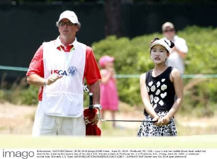 June 20, 2014 - Pinehurst, NC, USA - Lucy Li and her caddie Bryan Bush watch her shot on No. 2 during the second day of the 2014 U.S. Women s Open at Pinehurst No. 2 in Pinehurst, N.C., Friday, June 20, 2014. Li made par on the hole. Womens U.S. Open Golf - ZUMAm67
