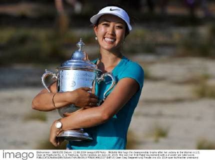 Michelle Wie hugs the championship trophy after her victory in the Women s U.S. Open at Pinehurst No. 2, in Pinehurst, North Carolina, on June 22, 2014. Wie won her first Major tournament with a 2-under-par total score.  PIN2014062227
