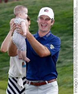 June 22, 2014 - Cromwell, Connecticut, U.S - Kevin Streelman holds his baby Sophie as he approaches the awards ceremony on the 18th green after the final round of the Travelers Championship at TPC River Highlands in Cromwell, Connecticut. Golf 2014 - Travelers Championship - Final Round - ZUMAw10
