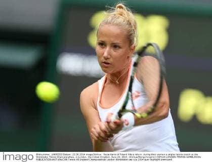 Paula Kania of Poland hits a return during their women s singles tennis match at the Wimbledon Tennis Championships, in London, the United Kingdom, June 23, 2014. (Xinhua MengxYongmin) (SP)UK-LONDON-TENNIS-WIMBLEDON 