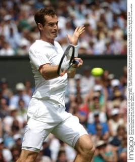 Britain s Andy Murray plays a forehand during his match on day one of the 2014 Wimbledon Championships in London on June 23, 2014.  LON2014062302