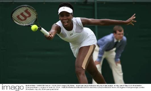American Venus Williams returns in her match on day one of the 2014 Wimbledon Championships in London on June 23, 2014.  LON2014062315