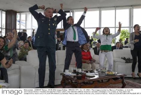 MEXICO CITY, Jun. 23, 2014 - This image provided by Mexico s Presidency on June 23, 2014 shows Mexican President Enrique Pena Nieto (2nd L) and National Defense Secretary Salvador Cienfuegos (1st L) react as they watch the Group A third round match of 2014 FIFA World Cup between Mexico and Croatia in Mexico City, capital of Mexico. 