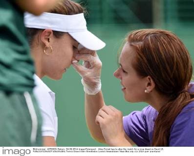 Alize Cornet has to stop the match for a nose bleed on Court 19. 