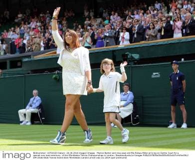Marion Bartoli and nine-year-old Elle Robus-Miller arriving on Centre Court for a special coin toss ceremony of the Wimbledon Tennis Championships in London. StephenxLockx xi-Images  IIM-2516-0026