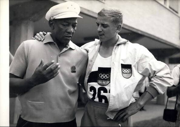 May 02, 1960 - Champions Past And present. Jesse Owens And Armin Hary. World famous athlete Jesse Owens who is now in Rome with members of the American Team - was to be seen this morning at the Olympic Village where he talked with Armin Hary the German sprinter who yesterday won the Gold Medal for winning the 100 Metres dash - in 10.2 which equals his own 10.2 Olympic Record - set up in a heat the previous day. Photo Shows:- Jesse Owens and Armin Hary - when they met in the Village this morning.  - ZUMAk09