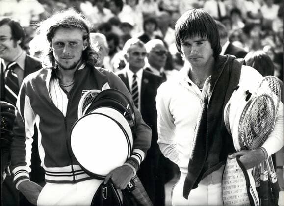 Jul. 07, 1977 - BJORN BORG RETAING HIS WIMBLEDON TITLE. BJORN BORG of Sweden retained his Men s Singles title at Wimbledon today, when he beat JIMMY CONNORS of American, after five sets of hard tennis, 3-6, 6-2, 6-1, 5-7, 6-4. KEYSTONE PHOTO SHOWS:- Victor and Vanquished BJORN BORG (left) and JIMMY CONNORS, leave the court after their treatments match.  - ZUMAk09