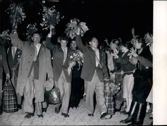 Jul. 07, 1954 - The German football-team arrived in lindau: with much flowers and presents the of Lindau the first place the German football-team reached in Germany welcomed the now world-champion. our pictures shows from left to right Peco Bauwens, Hans schäfer, Max Morlock.  - ZUMAk09