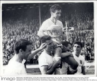 Apr. 15, 1961 - England Beat Scotland by 9-3 In London, Wembley International: England today Beat Scotland by nine goals to Three, in Soccer International at London, Wembley Stadium. The the Match was attended by H.M. The Queen and Prince Philip. Picture Shows: England Captain , Johnny Championship Trophy, as members of this team carry him aloft at London, Wembley today. The Queen presented the trophy to Haynes. On extreme left in Jimmy Greaves.  - ZUMAk09