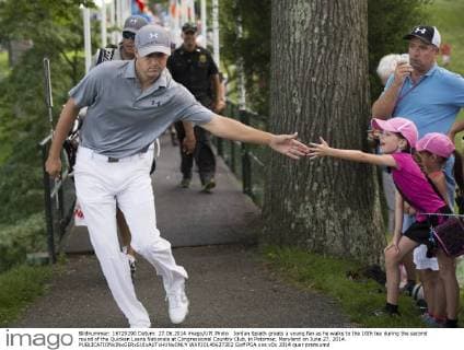 Jordan Spieth greets a young fan as he walks to the 10th tee during the second round of the Quicken Loans Nationals at Congressional Country Club, in Potomac, Maryland on June 27, 2014.  WAP20140627302