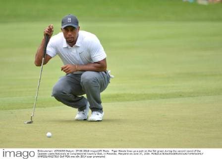 Tiger Woods lines up a putt on the 3rd green during the second round of the Quicken Loans Nationals at Congressional Country Club, in Potomac, Maryland on June 27, 2014.  WAP20140627316