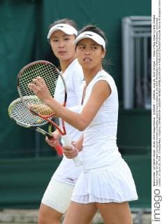 (140628) -- LONDON, June 28, 2014 (Xinhua) -- China s Peng Shuai (L) and Chinese Taipei s Hsieh Su-Wei react during the women s doubles second round match at the 2014 Wimbledon Championships at Wimbledon, southwest London, on June 28, 2014. (Xinhua Meng Yongmin) (SP)BRITAIN-LONDON-TENNIS-WIMBLEDON-DAY 6 