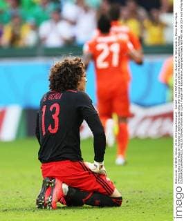 Football - 2014 FIFA World Cup - Round of 16: Netherlands vs. Mexico Diego Reyes of Mexico looks on as Klaas Jan Huntelaar of Netherlands celebrates after he scores a penalty at the Estadio Castelao, Fortaleza COLORSPORT IAN MACNICOL  5229-1