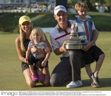 Justin Rose celebrates winning the Quicken Loans National with his family wife Kate, daughter Charlotte and son Leo, at Congressional Golf Course in Potomac, Maryland on June 29, 2014.  WAP20140629817