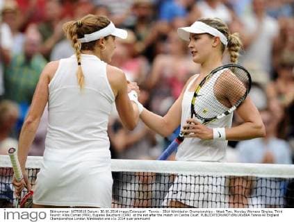 Tennis - 2014 Wimbledon Championships - Week Two, Monday Womens Singles, Third Round: Alize Cornet (FRA), Eugenie Bouchard (CAN) at the net after the match on Centre Court 
