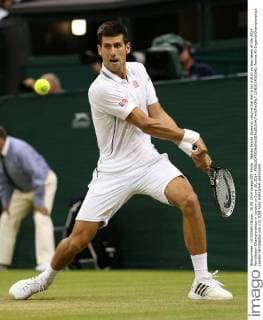 Sebian Novak Djokovic returns the ball in his match on day seven of the 2014 Wimbledon Championships in London on June 30, 2014.  LON2014063061