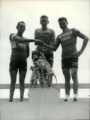 Jul. 18, 1962 - Frenchman Jacques Anquetil demonstrated his overwhelming superiority by winning the Tour de France a third time in 1962. Raymond Poulidor, who started the race with an arm in a cast, showed what he was capable of and Belgian Plankaert completed an average race. Picture: The first three to finish the Tour de France on a platform in the Parc des Princes: (from left to right) Plankaert, Jacques Anquetil, and Raymond Poulidor.  - ZUMAk09