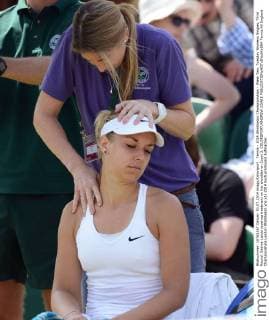 Tennis - 2014 Wimbledon Championships - Week Two, Tuesday Womens Singles, Third Round: Sabine Lisicki receives treatment on her shoulder on Court 3. COLORSPORT ANDREW COWIE 