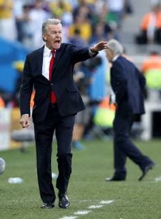 Switzerland s coach Ottmar Hitzfeld (L) gives instructions during a Round of 16 match between Argentina and Switzerland of 2014 FIFA World Cup at the Arena de Sao Paulo Stadium in Sao Paulo, on July 1, 2014. . 