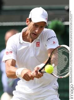 Serbia s Novak Djokovic returns a shot during the men s singles quarter final 