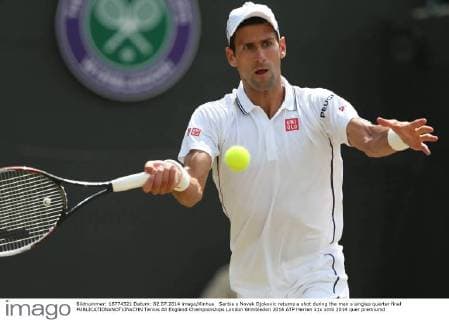 Serbia s Novak Djokovic returns a shot during the men s singles quarter final 