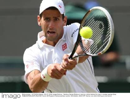 Serbia s Novak Djokovic returns a shot during the men s singles quarter final 