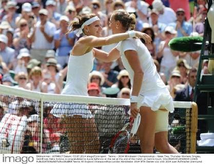 Tennis - 2014 Wimbledon Championships - Week Two, Thursday Womens Singles, SemiFinals Petra Kvitova is congratulated by Lucie Safarova at the net at the end of the match on Centre Court. COLORSPORT ANDREW COWIE 