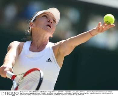 (140703) -- LONDON, July 3, 2014 (Xinhua) -- Simona Halep of Romania serves during the women s singles semifinal at the 2014 Wimbledon Championships in Wimbledon, southwest London, on July 3, 2014. 