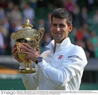 Serbian Novak Djokovic holds the Wimbledon trophy at the Men s Final of the 2014 Wimbledon Championships in London on July 06, 2014.  LON2014070603