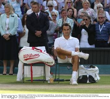 Swiss Roger Federer looks glum at the Men s Final of the 2014 Wimbledon Championships in London on July 06, 2014.  LON2014070610