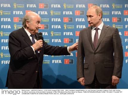 FIFA President Joseph Blatter (L) and Russian President Vladimir Putin talk during an official ceremony of the symbolic handover of the FIFA World Cup from Brazil to Russia.  RE14A217