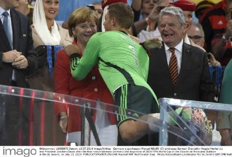 Germany s goalkeeper Manuel NEUER (C) embraces German Chancellor Angela Merkel (L) and President Joachim Gauck after the final match between Germany and Argentina of 2014 FIFA World Cup at the Estadio do Maracana Stadium in Rio de Janeiro, on July 13, 2014. 